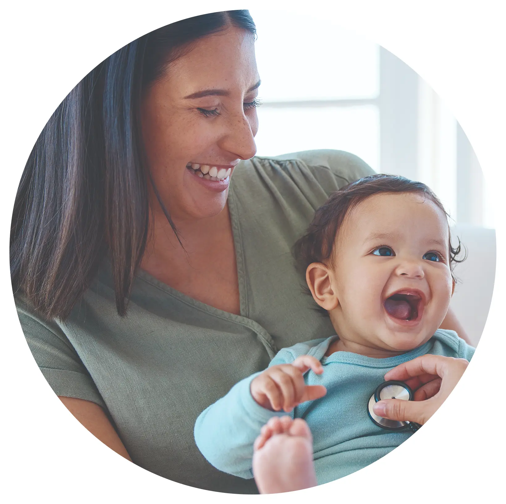 Laughing baby with mom at checkup