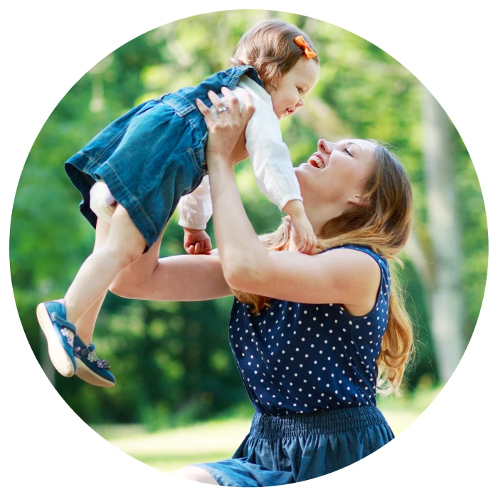 Young mom lifting up her daughter